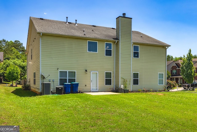 2689 Muskeg Ct SW, South Fulton, GA 30331 - rear view of house with a chimney, a lawn, a patio, and central AC