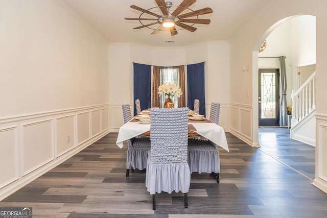 2689 Muskeg Ct SW, South Fulton, GA 30331 - dining room with arched walkways, ceiling fan, wood finished floors, a decorative wall, and crown molding