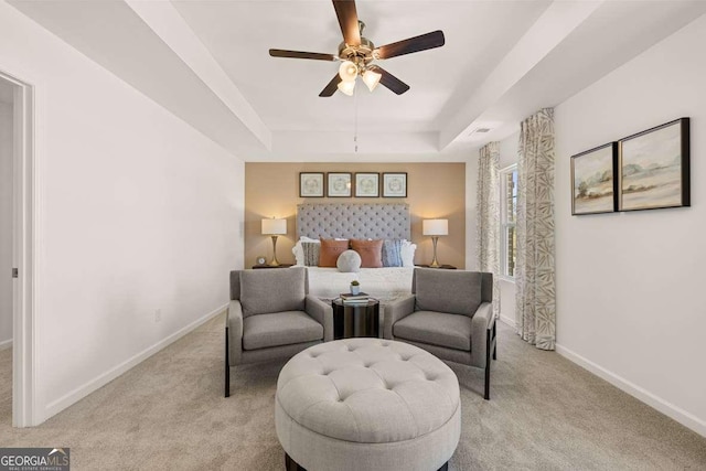 170 Aster Ave, Locust Grove, GA 30248 - bedroom featuring a raised ceiling, baseboards, light carpet, and a ceiling fan
