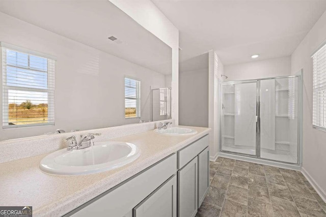170 Aster Ave, Locust Grove, GA 30248 - full bath with a shower stall, double vanity, baseboards, and stone finish floors
