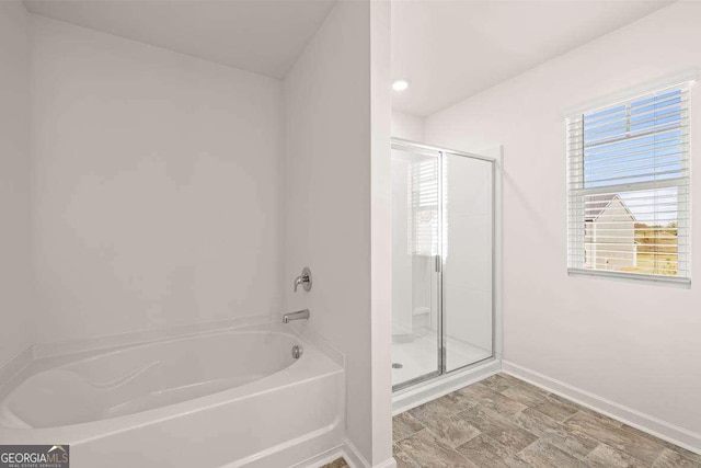 170 Aster Ave, Locust Grove, GA 30248 - full bathroom with a garden tub, a stall shower, and baseboards