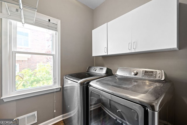 4527 Village Springs Run, Dunwoody, GA 30338 - washroom featuring washing machine and clothes dryer, cabinet space, and healthy amount of natural light