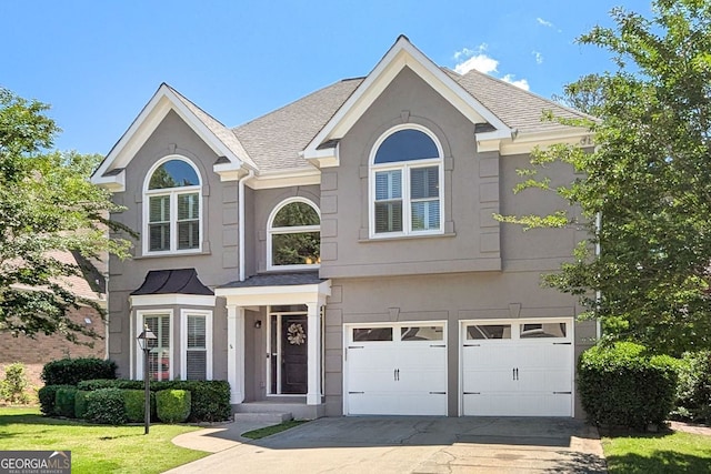 4527 Village Springs Run, Dunwoody, GA 30338 - traditional-style home featuring an attached garage, driveway, stucco siding, and a front lawn