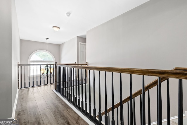 4527 Village Springs Run, Dunwoody, GA 30338 - hallway with wood finished floors, a chandelier, and baseboards