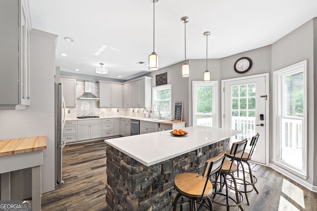 4527 Village Springs Run, Dunwoody, GA 30338 - kitchen with wall chimney exhaust hood, a sink, dark wood finished floors, stainless steel appliances, and tasteful backsplash