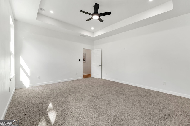8544 Plumtree Dr, Riverdale, GA 30274 - spare room with a tray ceiling, ceiling fan, carpet floors, recessed lighting, and baseboards