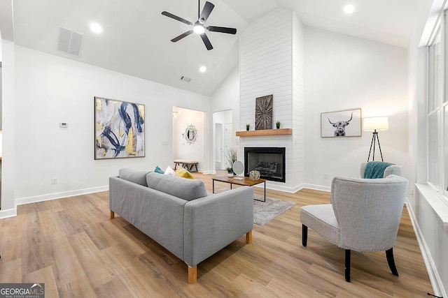8544 Plumtree Dr, Riverdale, GA 30274 - living area with ceiling fan, a large fireplace, high vaulted ceiling, wood finished floors, and baseboards