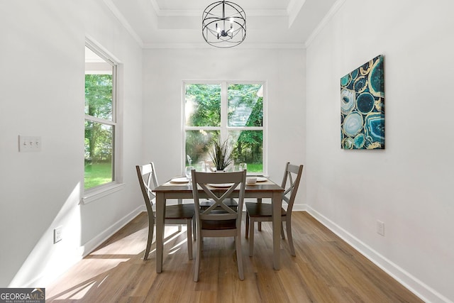 8544 Plumtree Dr, Riverdale, GA 30274 - dining space featuring a chandelier, healthy amount of natural light, wood finished floors, ornamental molding, and baseboards