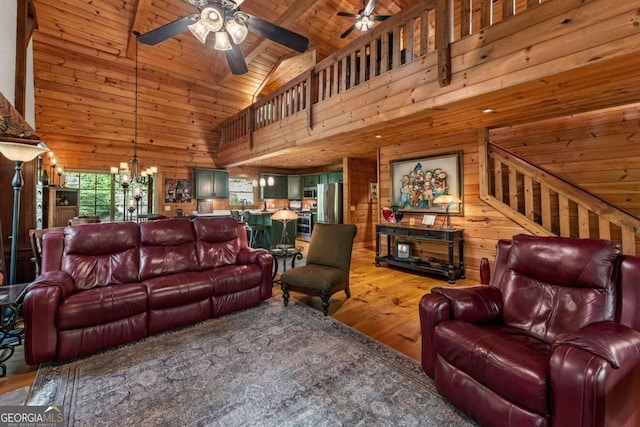 744 Dover Falls Trl, Ellijay, GA 30540 - living area with wood ceiling with exposed beams, wood-type flooring, ceiling fan, wood walls, and a chandelier