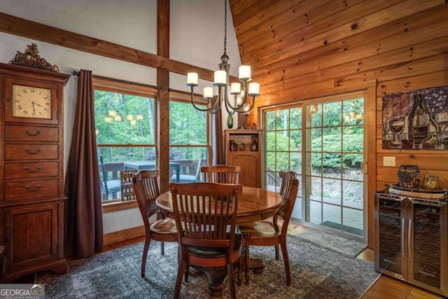 744 Dover Falls Trl, Ellijay, GA 30540 - dining room with a chandelier, beverage cooler, wooden walls, wood finished floors, and lofted ceiling