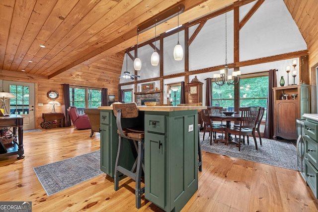 744 Dover Falls Trl, Ellijay, GA 30540 - kitchen with green cabinetry, a chandelier, light wood-style flooring, wood walls, and light countertops