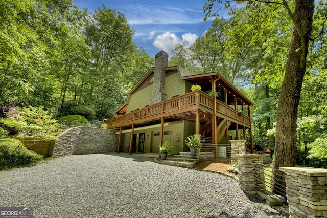 744 Dover Falls Trl, Ellijay, GA 30540 - view of front of home featuring a chimney, a wooden deck, stairway, driveway, and an attached garage