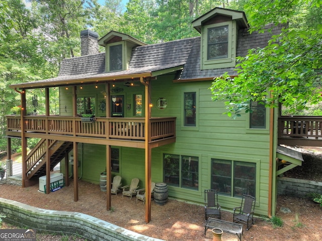 744 Dover Falls Trl, Ellijay, GA 30540 - rear view of house featuring roof with shingles, a wooden deck, a chimney, stairway, and a patio area