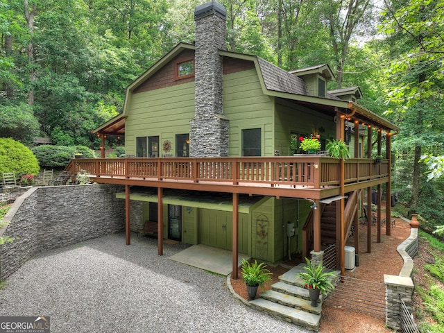 744 Dover Falls Trl, Ellijay, GA 30540 - back of property with a patio area, a deck, a chimney, and stairway