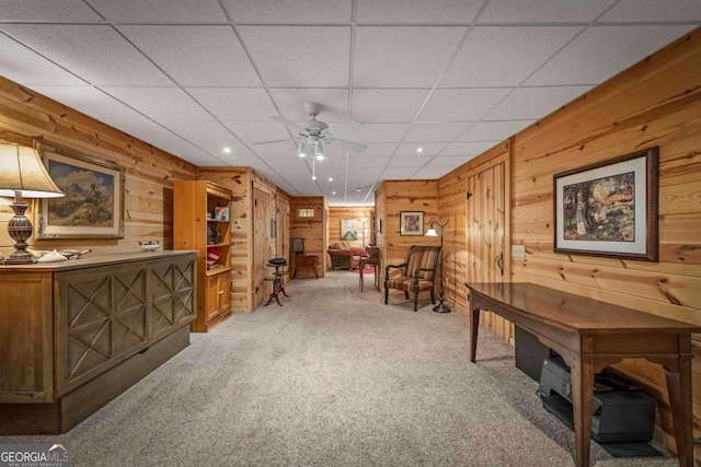 744 Dover Falls Trl, Ellijay, GA 30540 - sitting room featuring wood walls, light carpet, a ceiling fan, and a drop ceiling