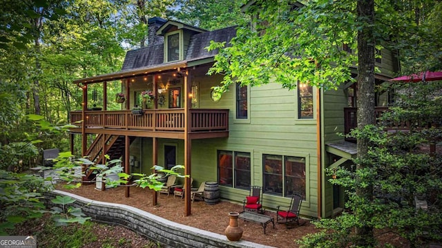744 Dover Falls Trl, Ellijay, GA 30540 - rear view of property featuring a deck, stairway, roof with shingles, mansard roof, and a chimney