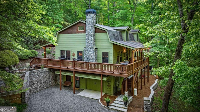 744 Dover Falls Trl, Ellijay, GA 30540 - rear view of property with a patio, a wooden deck, a view of trees, a chimney, and a gambrel roof