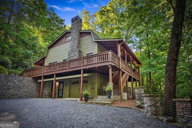 744 Dover Falls Trl, Ellijay, GA 30540 - view of front of home with a deck, a chimney, and gravel driveway