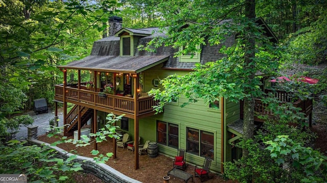 744 Dover Falls Trl, Ellijay, GA 30540 - rear view of house featuring a deck, a chimney, stairs, and roof with shingles