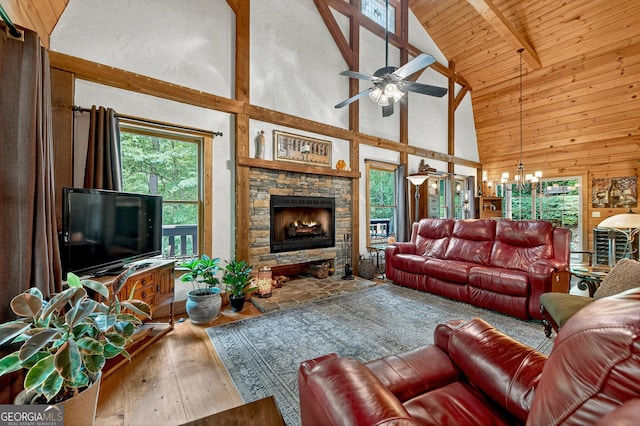 744 Dover Falls Trl, Ellijay, GA 30540 - living room featuring high vaulted ceiling, wood-type flooring, a chandelier, a stone fireplace, and a ceiling fan
