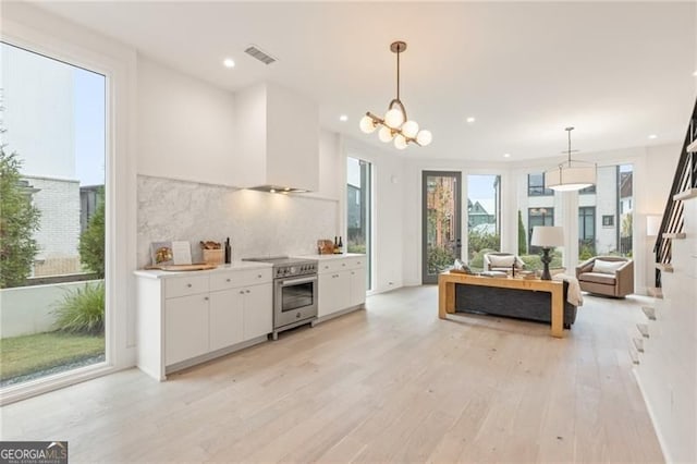 370 2nd St, Fayetteville, GA 30214 - kitchen featuring high end range, white cabinetry, light wood finished floors, plenty of natural light, and recessed lighting