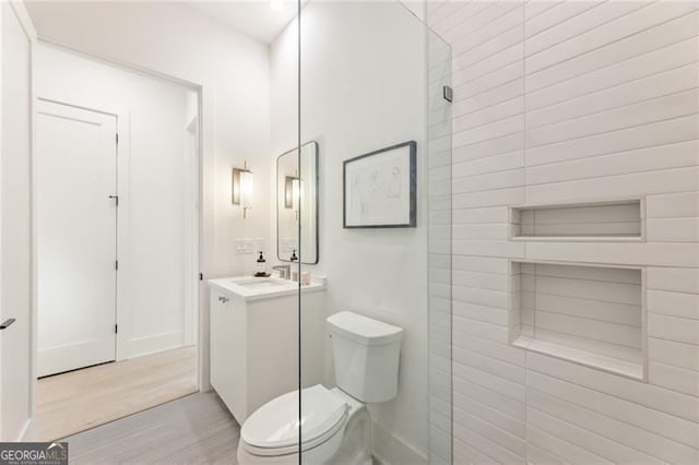 370 2nd St, Fayetteville, GA 30214 - bathroom featuring toilet, vanity, and wood finished floors