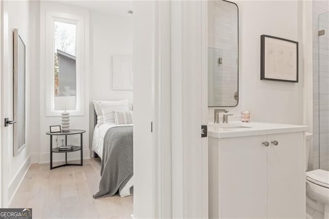 370 2nd St, Fayetteville, GA 30214 - bedroom featuring a sink, light wood-style floors, and baseboards
