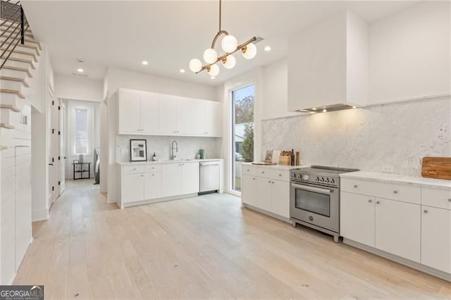 370 2nd St, Fayetteville, GA 30214 - kitchen with stainless steel appliances, white cabinetry, light wood-type flooring, light countertops, and recessed lighting