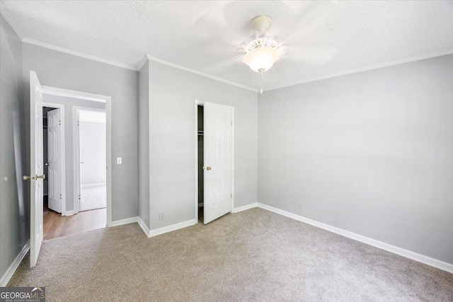 165 Forest Hill Dr, Eatonton, GA 31024 - unfurnished bedroom with carpet flooring, ornamental molding, a textured ceiling, baseboards, and a closet