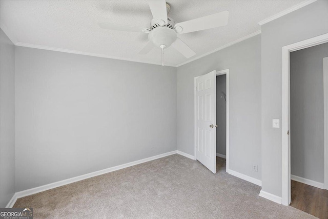 165 Forest Hill Dr, Eatonton, GA 31024 - unfurnished bedroom featuring carpet, ornamental molding, baseboards, and a ceiling fan