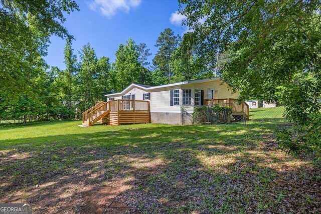 165 Forest Hill Dr, Eatonton, GA 31024 - rear view of house featuring a wooden deck, stairway, and crawl space