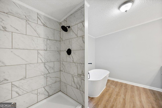 165 Forest Hill Dr, Eatonton, GA 31024 - bathroom featuring ornamental molding, a textured ceiling, a tile shower, wood finished floors, and a freestanding bath