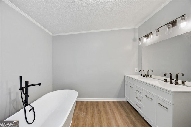 165 Forest Hill Dr, Eatonton, GA 31024 - bathroom featuring wood finished floors, a soaking tub, double vanity, ornamental molding, and a textured ceiling