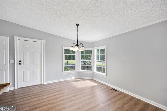 165 Forest Hill Dr, Eatonton, GA 31024 - unfurnished dining area featuring a textured ceiling, a chandelier, wood finished floors, and baseboards