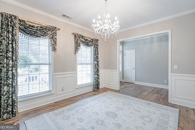 1521 Walthour Rd, Savannah, GA 31410 - empty room with a chandelier, wainscoting, wood finished floors, and ornamental molding