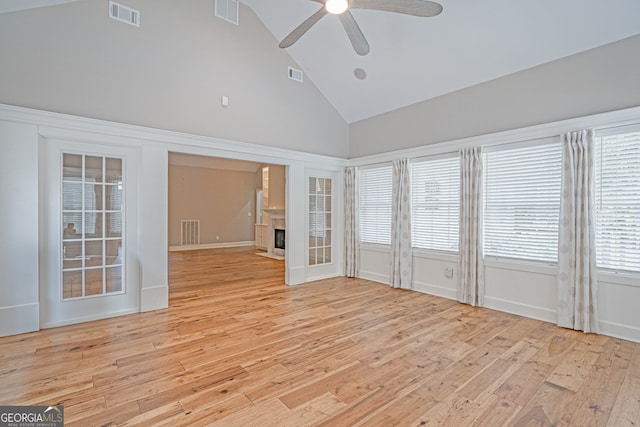 1521 Walthour Rd, Savannah, GA 31410 - unfurnished room featuring high vaulted ceiling, a ceiling fan, light wood finished floors, and a fireplace