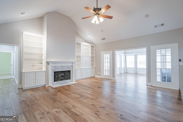 1521 Walthour Rd, Savannah, GA 31410 - unfurnished living room featuring a ceiling fan, built in features, a high end fireplace, light wood finished floors, and baseboards