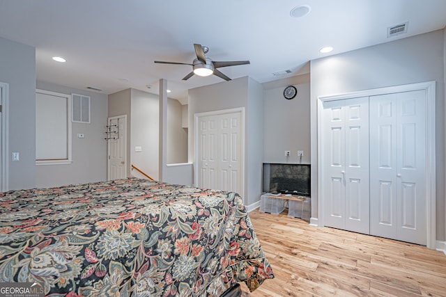 1521 Walthour Rd, Savannah, GA 31410 - bedroom with multiple closets, wood finished floors, recessed lighting, a fireplace, and baseboards