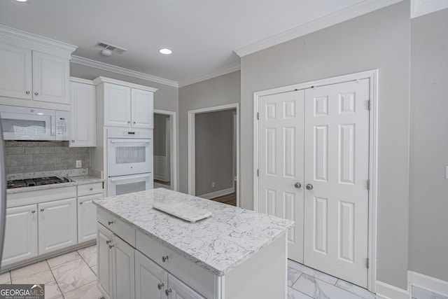 1521 Walthour Rd, Savannah, GA 31410 - kitchen with white appliances, light marble finish floors, recessed lighting, ornamental molding, and a center island