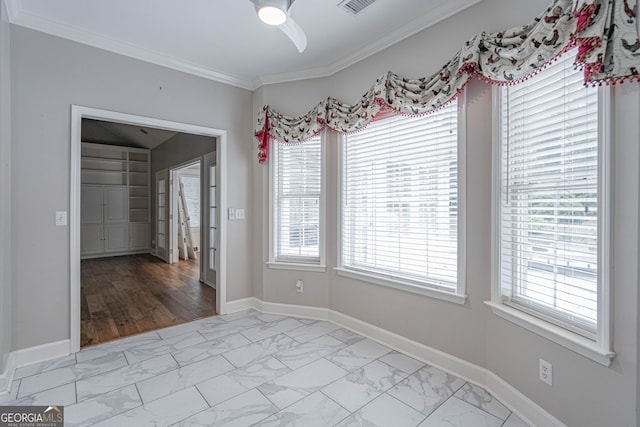 1521 Walthour Rd, Savannah, GA 31410 - unfurnished dining area featuring light marble finish flooring, a ceiling fan, crown molding, and baseboards