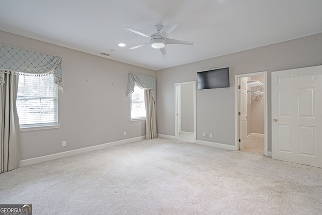 1521 Walthour Rd, Savannah, GA 31410 - unfurnished bedroom with multiple windows, carpet, baseboards, a walk in closet, and recessed lighting