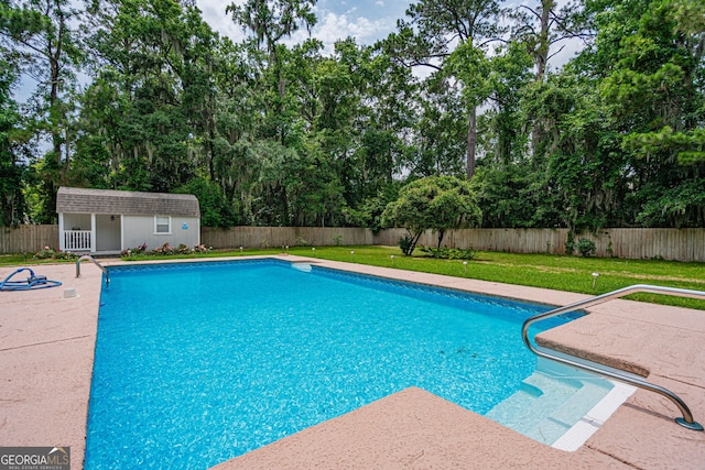 1521 Walthour Rd, Savannah, GA 31410 - view of swimming pool with an outbuilding, a patio, and view of wooded area