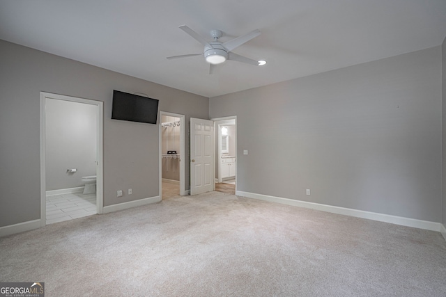 1521 Walthour Rd, Savannah, GA 31410 - unfurnished bedroom with light carpet, baseboards, ensuite bathroom, a spacious closet, and a ceiling fan