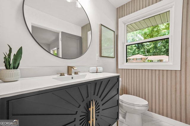 3337 Toney Dr, Decatur, GA 30032 - bathroom featuring vanity, wallpapered walls, toilet, and marble look tiles
