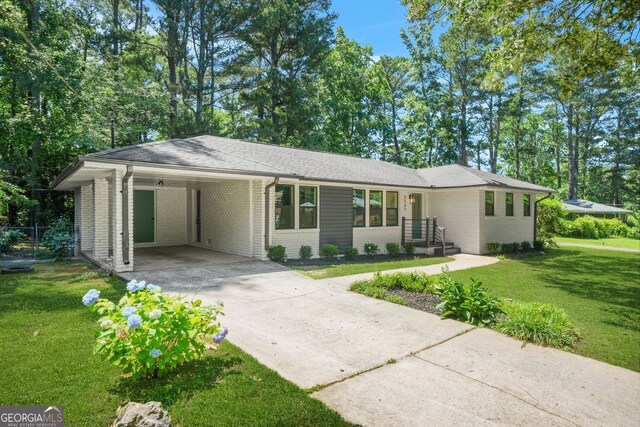 3337 Toney Dr, Decatur, GA 30032 - single story home featuring brick siding, driveway, a front yard, and a carport