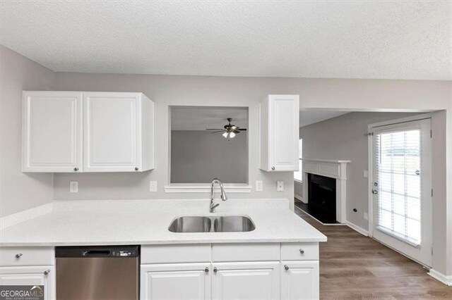 11827 Spring Lake Way, Fayetteville, GA 30215 - kitchen with stainless steel dishwasher, a sink, a ceiling fan, white cabinetry, and a textured ceiling