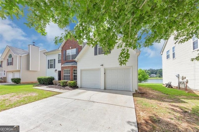 11827 Spring Lake Way, Fayetteville, GA 30215 - traditional-style house with a garage, concrete driveway, a water view, and a front lawn