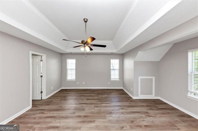 11827 Spring Lake Way, Fayetteville, GA 30215 - unfurnished living room with a tray ceiling, a ceiling fan, wood finished floors, and baseboards