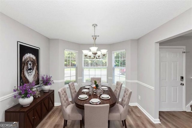 11827 Spring Lake Way, Fayetteville, GA 30215 - dining room with light wood-style floors, a chandelier, baseboards, and a textured ceiling