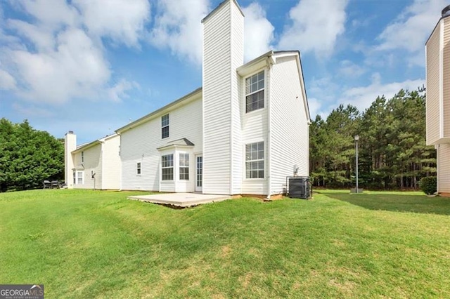 11827 Spring Lake Way, Fayetteville, GA 30215 - back of property featuring a chimney, central AC, a lawn, and a patio